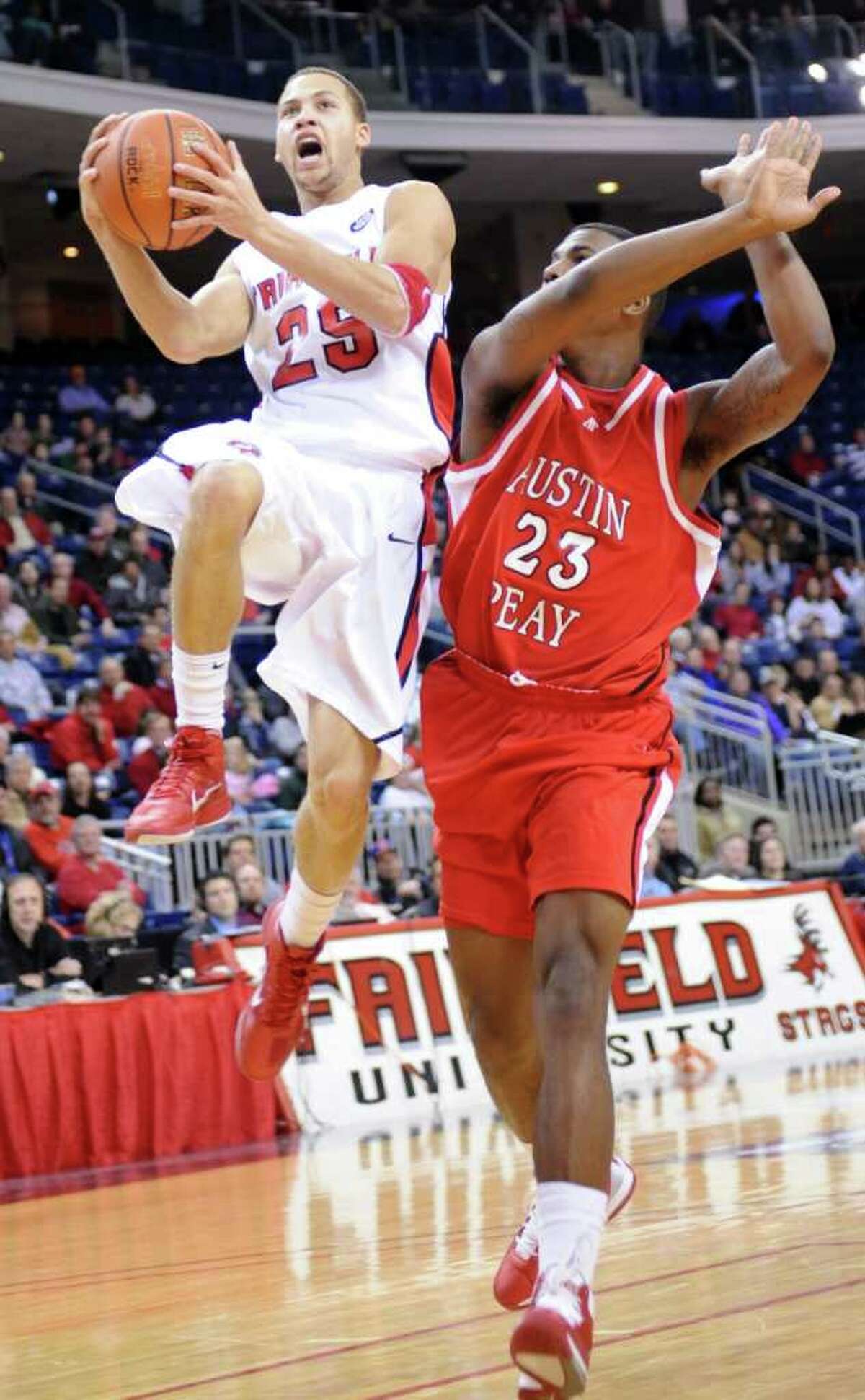 Fairfield's Colin Nickerson is fouled by Austin Peay's Josh Terry during their game at the Webster Bank Arena at Harbor Yard in Bridgeport, Conn. Saturday, Feb. 19, 2011.