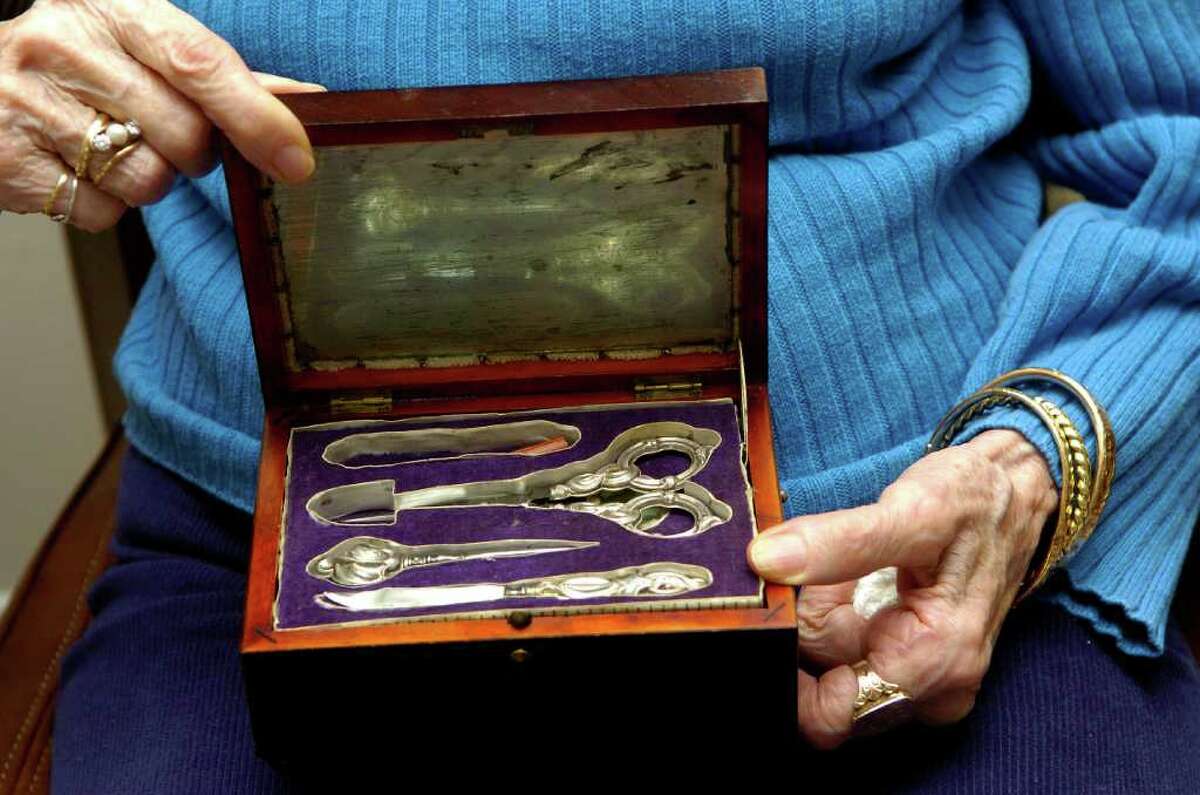 Elizabeth Goldfarb holds a sewing kit and music box that was her grandmothers that she got out of Germany before WWll when she left at 17 on the Kindertransport taking children from Germany to England. She's pictured at home in herapartment at Edgehill, a retirement community, in stamford, Conn. on Monday February 21, 2011.