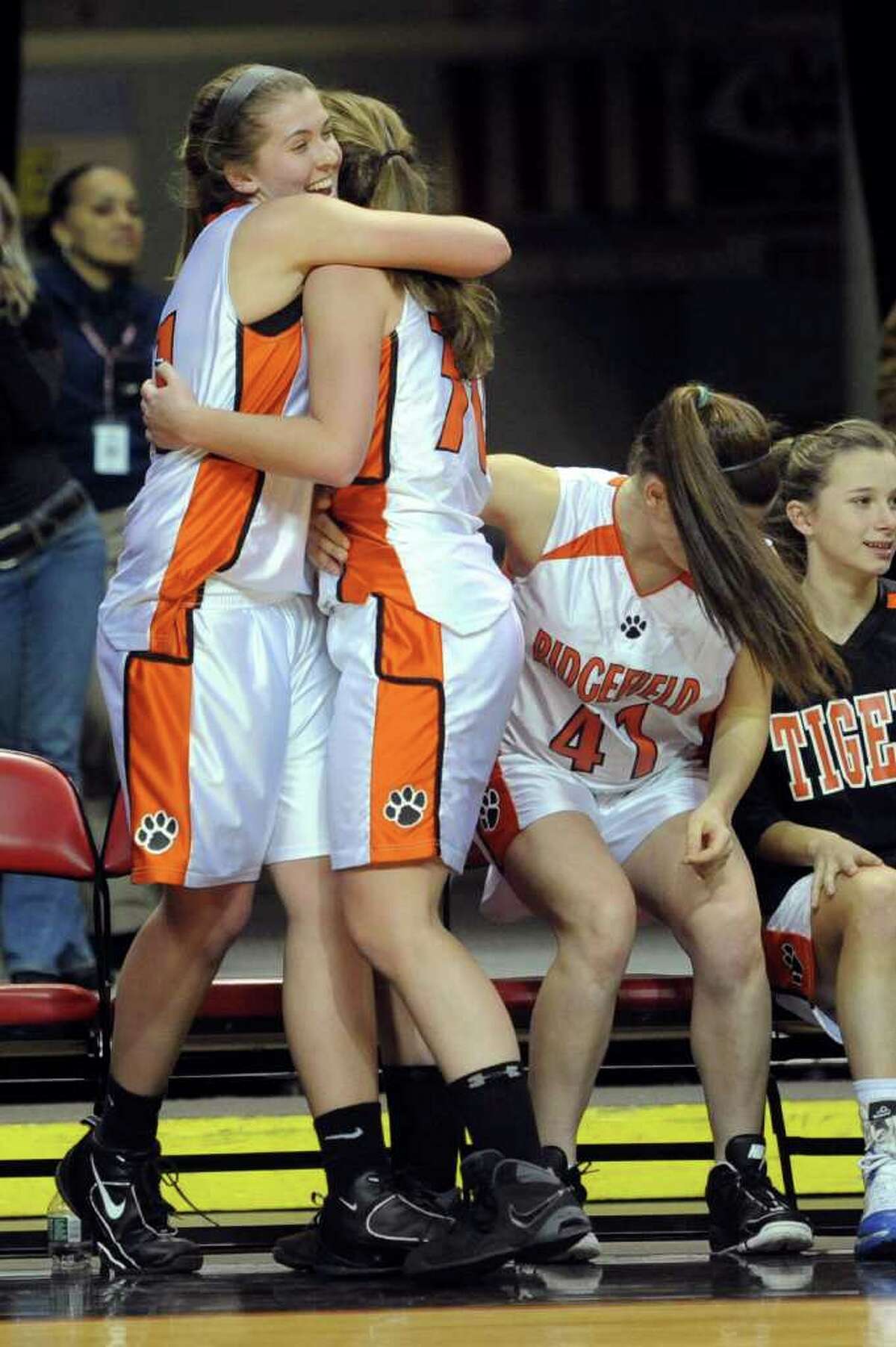 The Ridgefield bench celebrates a win after Tuesday's FCIAC girls basketball semifinal game at the Webster Bank Arena at Harbor Yard on Feburary 22, 2011.