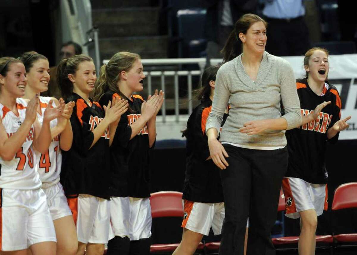 Ridgefield's bench and coach Katie Smith celebrate winning Tuesday's FCIAC girls basketball semifinal game at the Webster Bank Arena at Harbor Yard on Feburary 22, 2011.