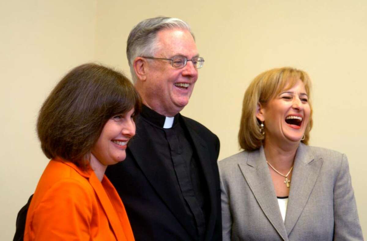Patrice Kopas principal of Greenwich Catholic School, Msgr. J. Peter Cullen, Vicar General of the Diocese of Bridgeport and Pastor of Saint Michael the Archangel Parish in Greenwich, and Lisa Maguire, chair of the Greenwich Catholic School's advisory board, from left, celebrate their Blue Ribbon win Tuesday Sept. 15, 2009 at The Catholic Center in Bridgeport, CT.