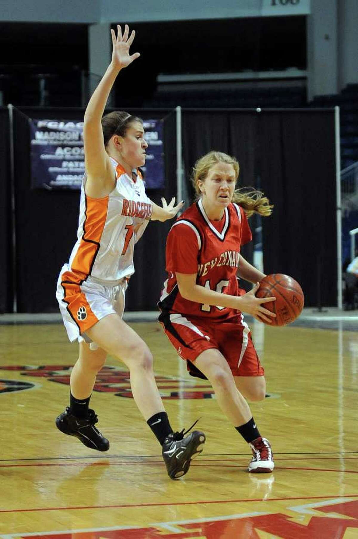 New Canaan's Sara Mannelly dribbles past Ridgefield's Kathryn Cholko during Tuesday's FCIAC girls basketball semifinal game at the Webster Bank Arena at Harbor Yard on Feburary 22, 2011.