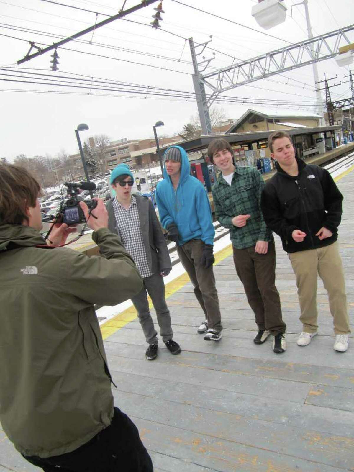 The FWHS Acafellas, an a cappella group made up of Fairfield Warde High School teens, shoot a video along the train track in downtown Fairfield Monday afternoon. The group members, from left to right, are Johnny Shea, Sam Warnick, Zach Parfitt and Tim Veit.
