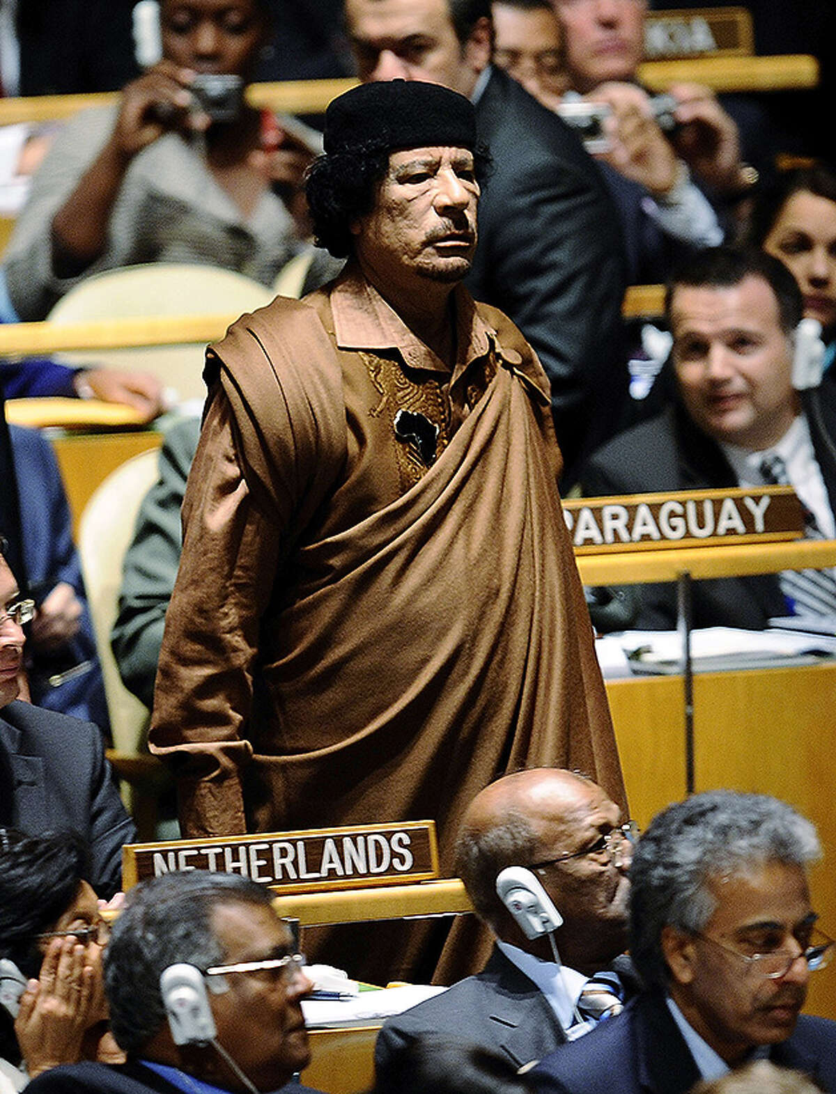 Libyan leader Colonel Moammar Gadhafi walks through the chamber at the 64th General Assembly at United Nations Headquarters on September 23, 2009 in New York City.