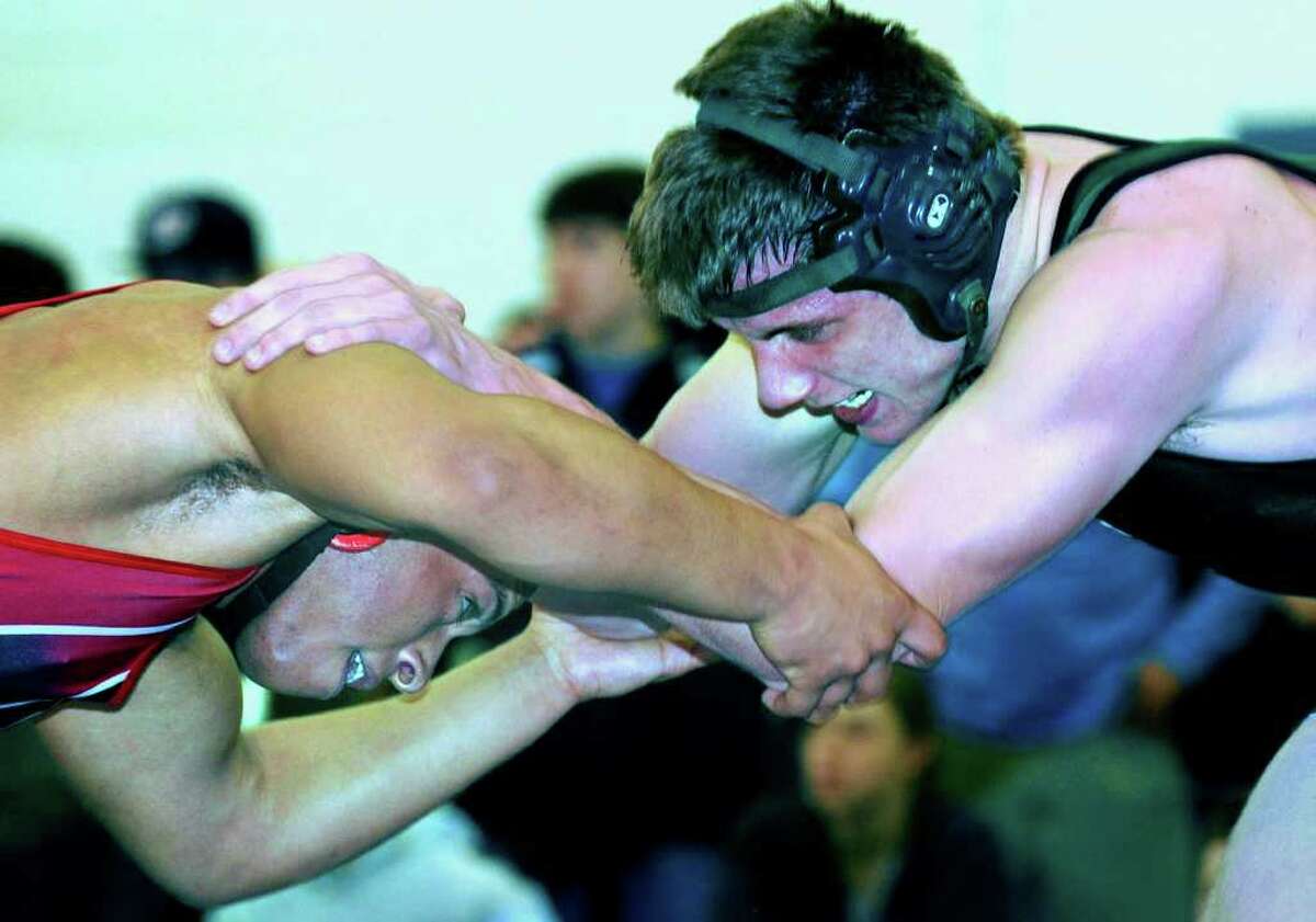 SPECTRUM/Karl Bradshaw, right, of New Milford High School wrestling battles Alex Delaney of Fairfield Warde in the 171-pound weight class semifinals during the state class 'L' tournament at Bristol Eastern High School. Feb. 19, 2011.