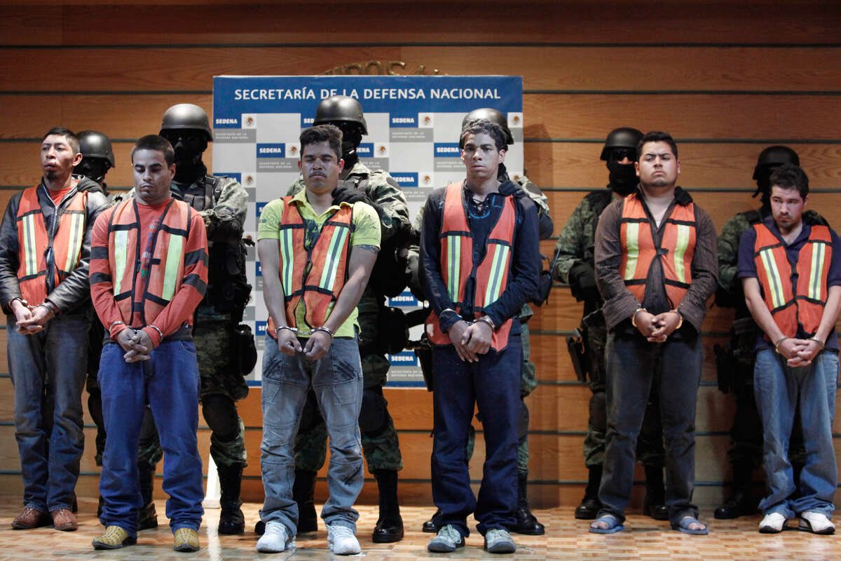 Authorities say U.S. agent Jaime Zapata was the victim of Julian Zapata Espinoza, alias “El Piolin” or “Tweety Bird,” and the other drug gunmen. The suspects (Zapata Espinoza is third from the left) are presented to the media in Mexico City.