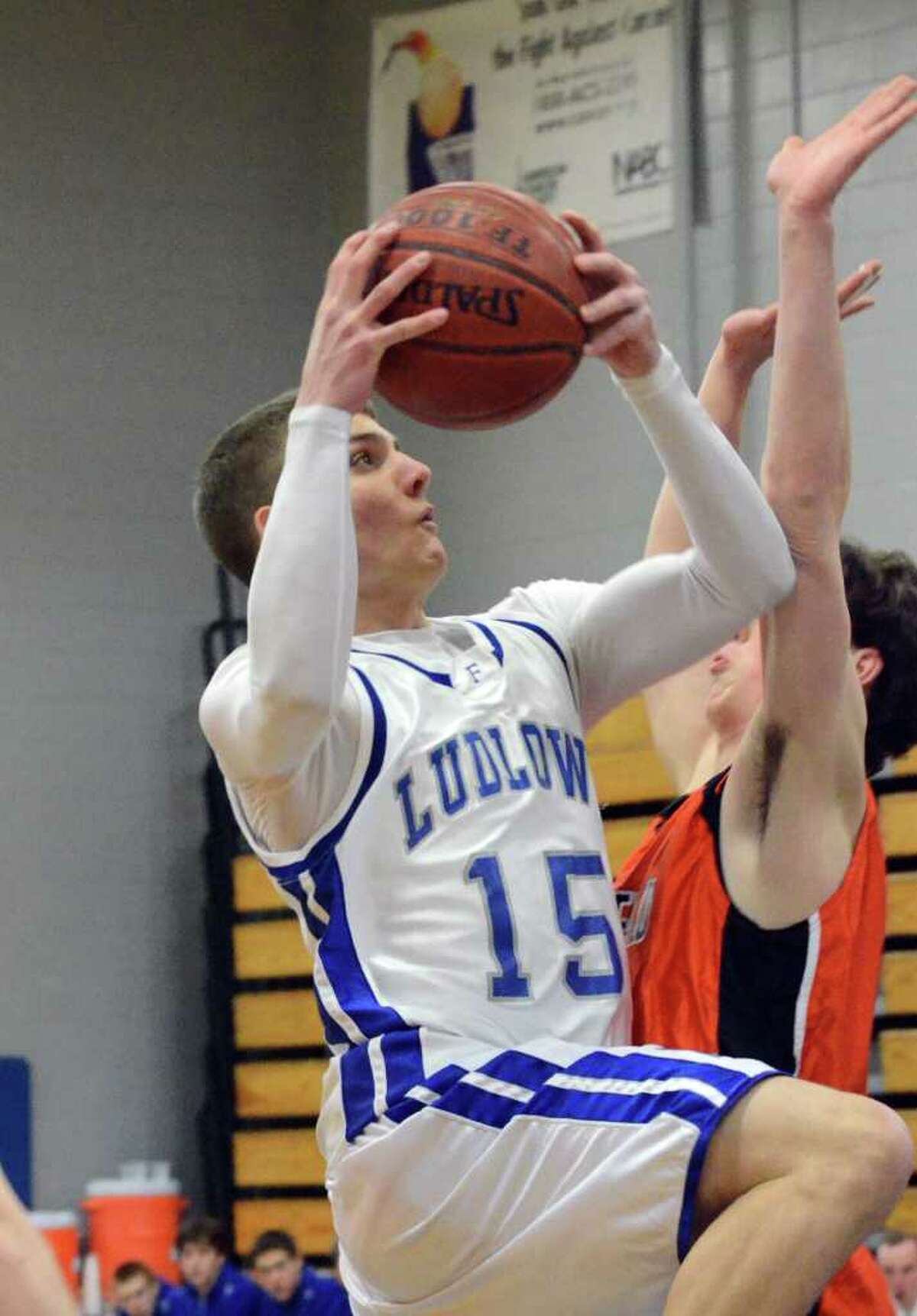 Fairfield Ludlowe's Erik Krumins goes up for a shot against Ridgefield's Seth von Kuhn during the boys basketball game at Ludlowe on Wednesday, Feb. 23, 2011.