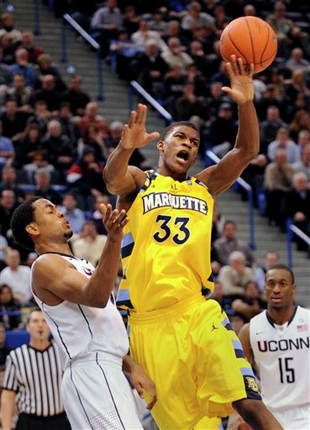 Marquette's Jimmy Butler, right, is fouled by UConn's Jamal Coombs-McDaniel during the first half of an NCAA college basketball game in Hartford, Conn., on Thursday, Feb. 24, 2011.  