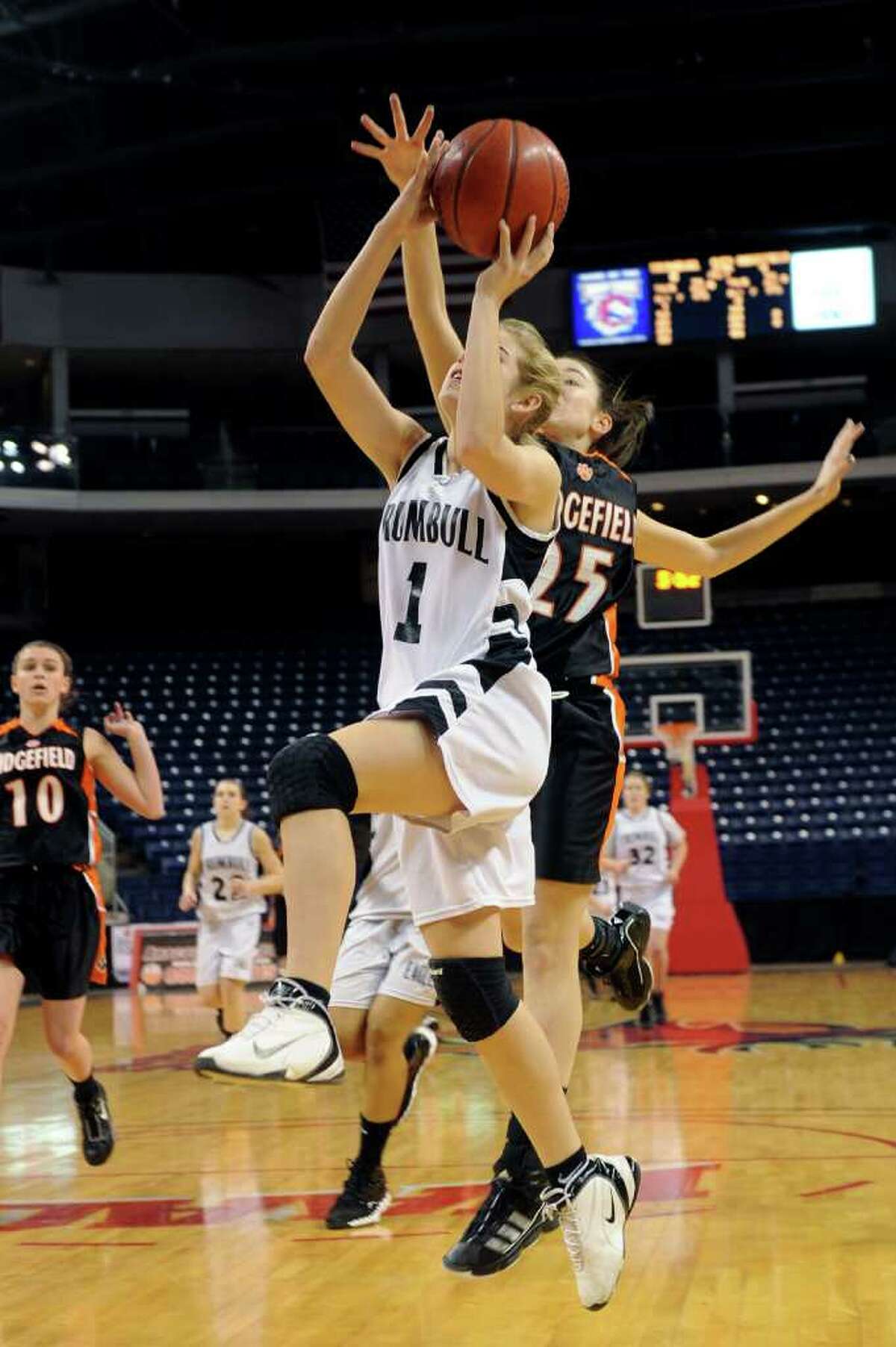Trumbull's Alexa Pfohl puts up a shot as Ridgefield's Molly Welch defends during Thursday's FCIAC girls basketball championship game at Webster Bank Arena at Harbor Yard on February 24, 2011. Pfohl was named Most Valuable Player after the game.