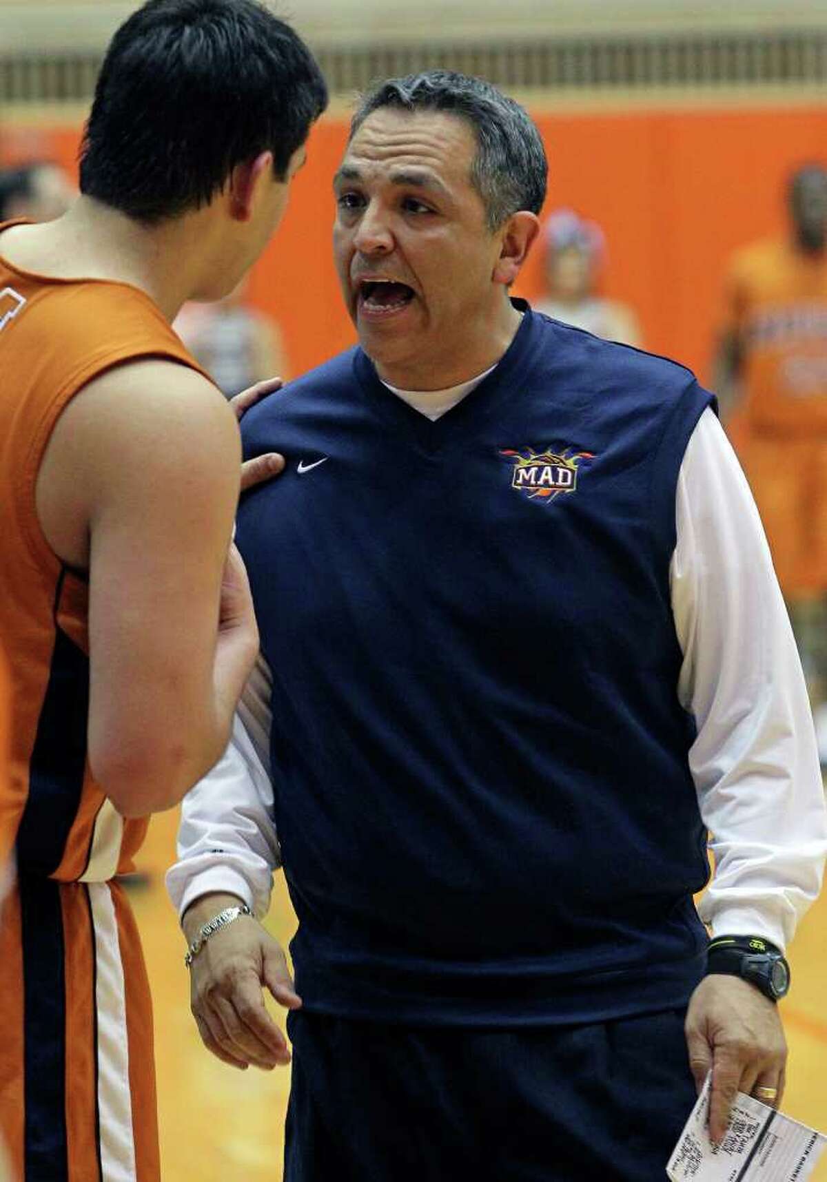 SPORTS Maverick's coach John Valenzuela talks with a player on the sideline as Clark beats Madison 49-37 in 5A boys basketball playoffs at the UTSA Convocation Center on February 24, 2011. Tom Reel/Staff