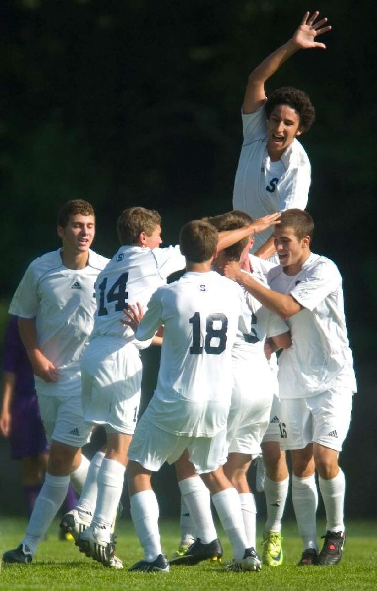 Staples High School players, including Jack Hennessy, top, celebrate after a goal in the first half of an FCIAC soccer match versus Westhill High School at Staples High School in Westport, Conn. on Tuesday, Sept. 15, 2009.
