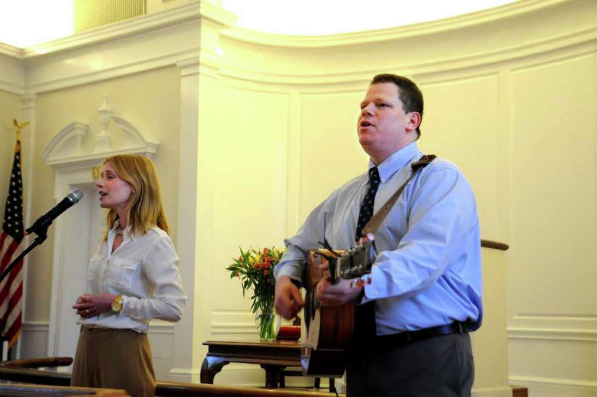 Lynn Witty and and her husband Sean sing at his installation at the First Church of Round Hill on Sunday, Feb. 27, 2011.