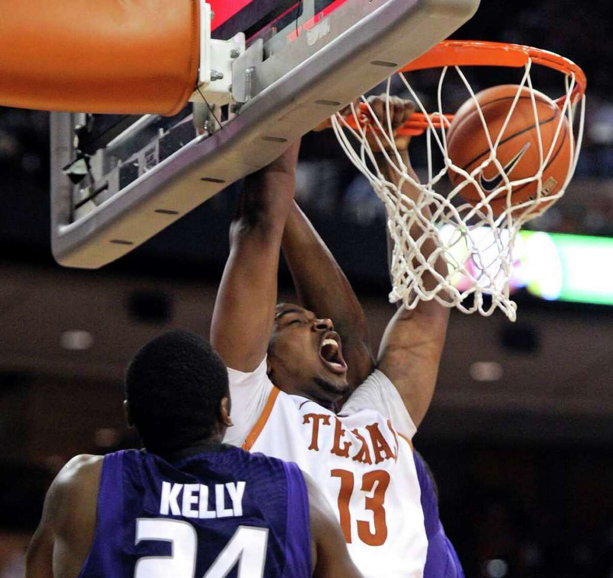 Texas forward Tristan Thompson (center) dunks the ball against Kansas State forward Curtis Kelly (front) and center Jordan Henriquez-Roberts (rear) during the first half on Monday, Feb. 28, 2011, in Austin.