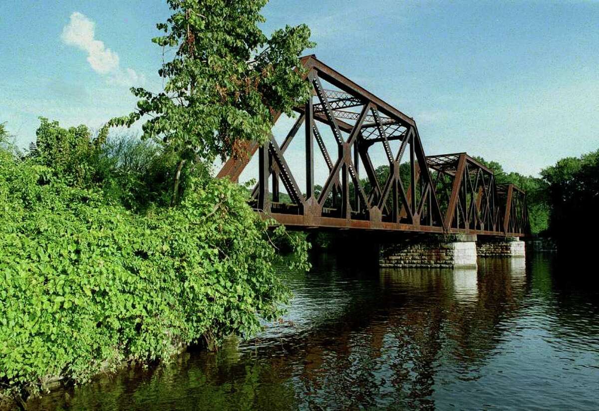 SPECTRUM/The venerable railroad bridge spanning Housatonic River just south iof the village center would get plenty more traffic if passenger serve were to be revived to New Milford and points north.