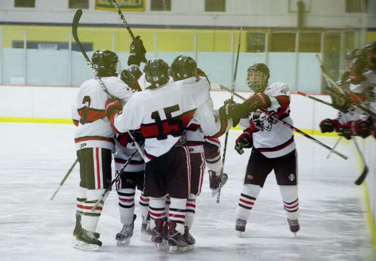 New Canaan celebrate Reed Harper's goal as the Darien Blue Wave and the New Canaan Rams face off in the FCIAC semifinals at Terry Conners Rink in Stamford, Conn., March 2, 2011. New Canaan won, 1-0.