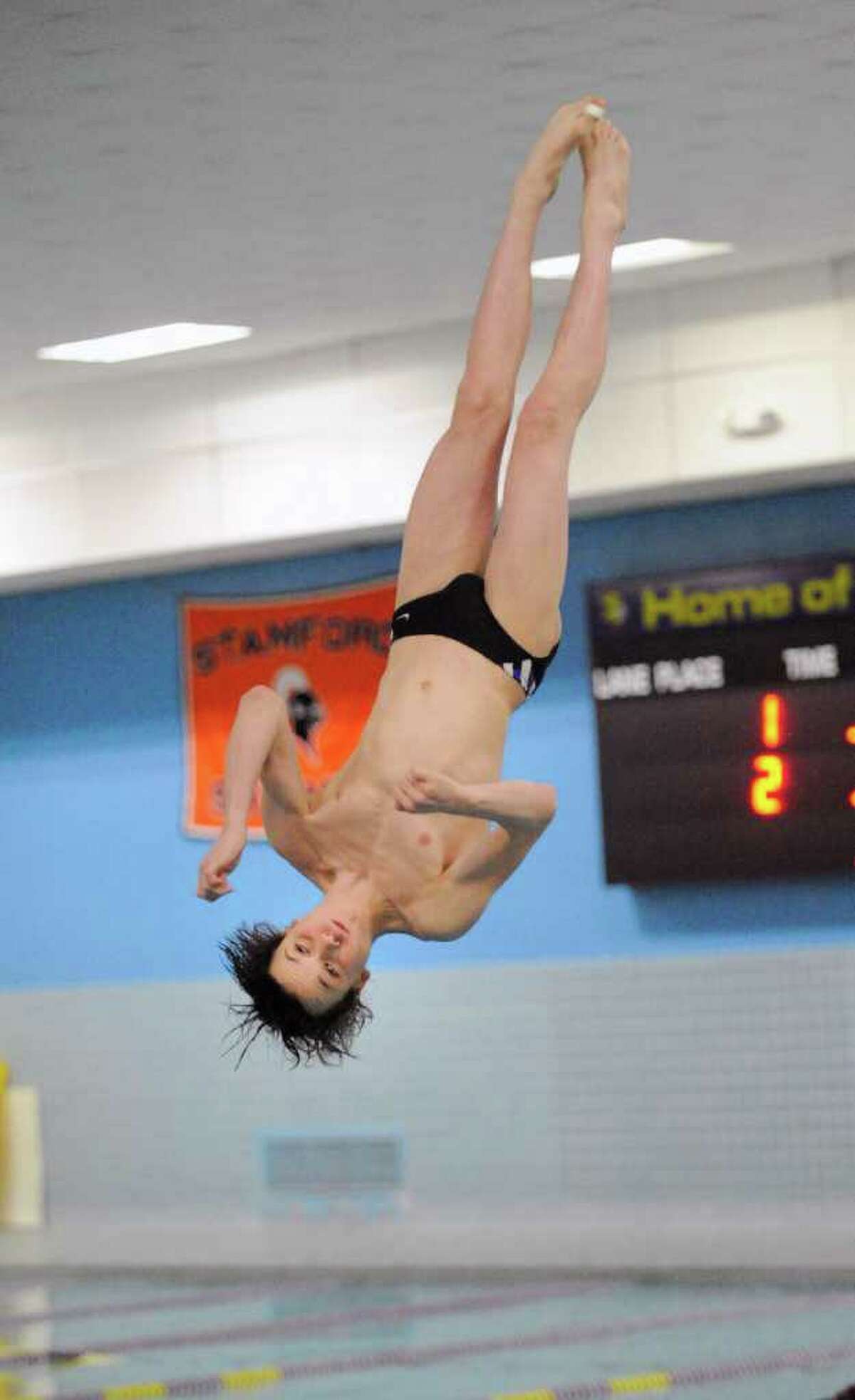 Sean Burston of the Westhill/Stamford High Schools combined swim team, competes in the FCIAC Diving finals at Westhill High School, Stamford, Wednesday night, March 2, 2011.
