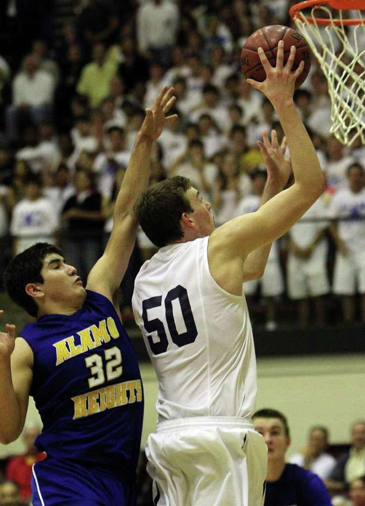 Alamo Heights' Brandon Garcia (32) attempts to defend against Boerne Champion's Dallas Quick (50) in the second half in Class 4A basketball playoffs at Littleton Gym on Wednesday, Mar. 2, 1011. Quick was fouled and the shot and helped Boerne Champion defeat Alamo Heights, 53-47. Kin Man Hui/kmhui@express-news.net