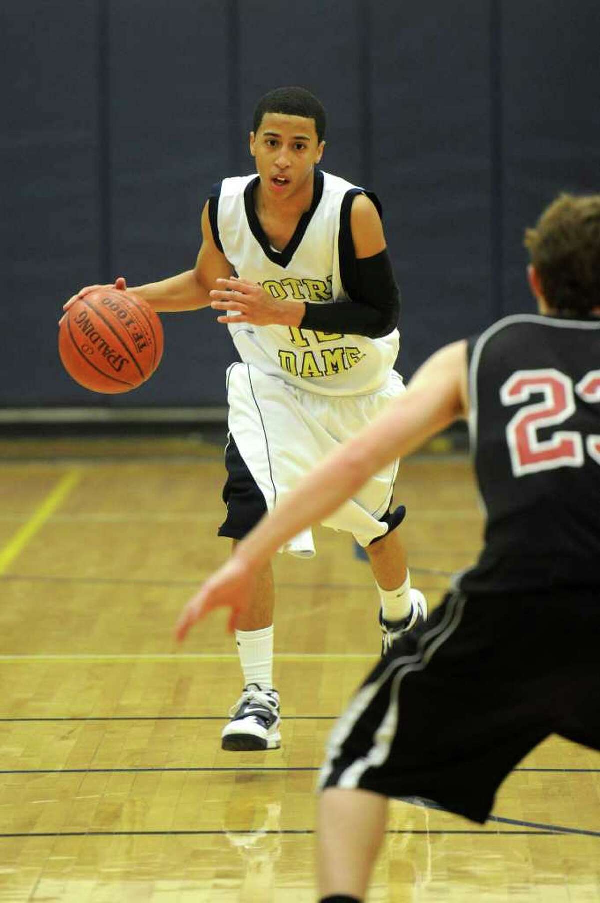 Notre Dame's Tre McPhersin dribbles during Thursday's SWC boys basketball final at Weston High School on March 3, 2011.