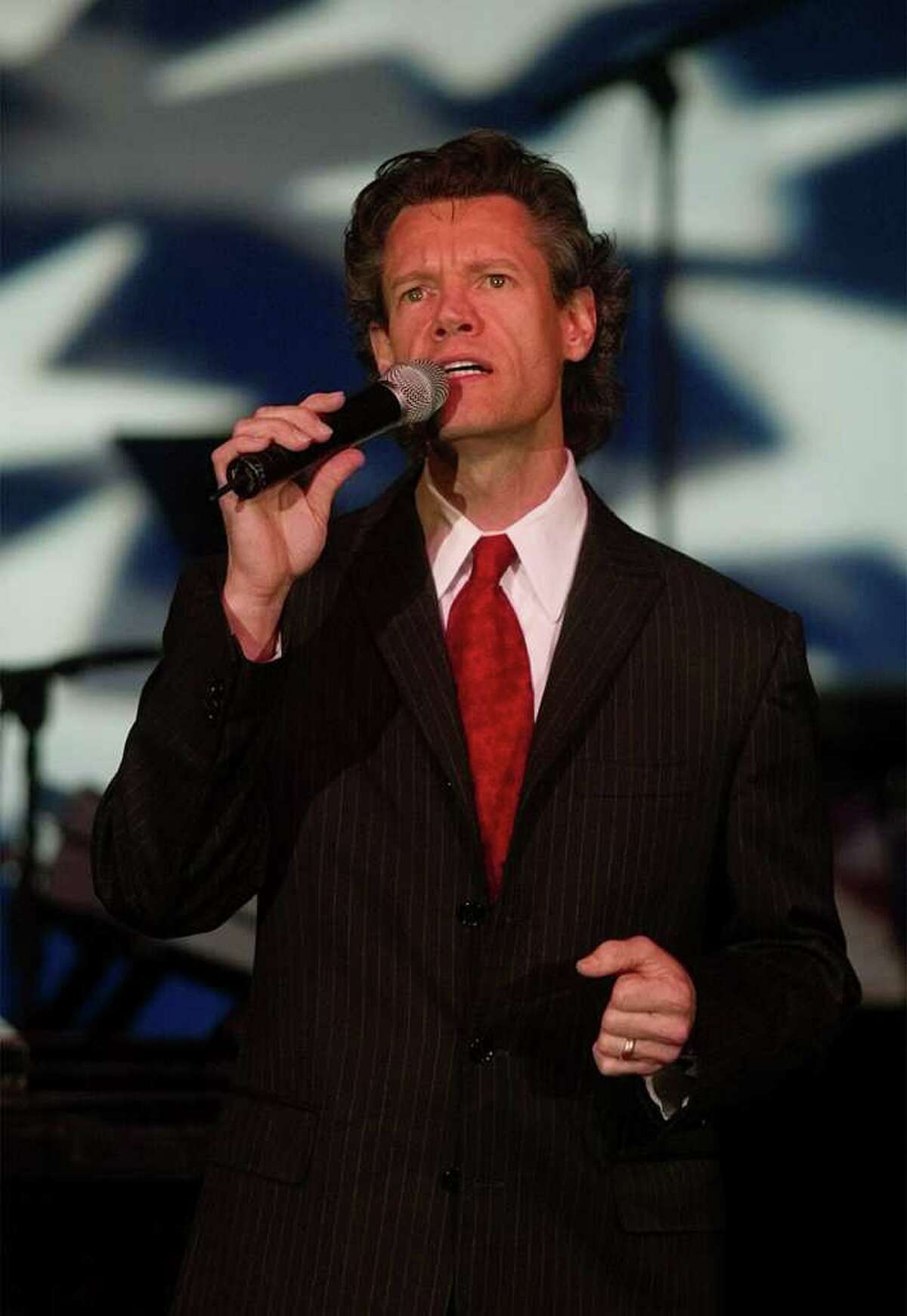 Country music star Randy Travis performs for more than 1,000 family members of the lost and wounded and military personnel from the Pentagon who attended Washington Honors America's Heroes of Freedom concert at Constitution Hall, Wednesday, Sept. 11, 2002.