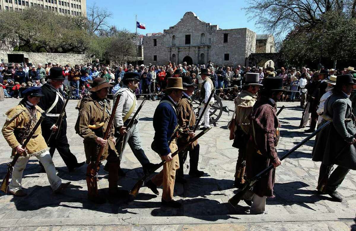 The re-enactment of the battle at the Alamo is watched by hundreds of people lining Alamo Plaza on Saturday, Mar. 5, 2011. Re-enactors dressed in period costumes for the event marked the 175th anniversary of the battle.