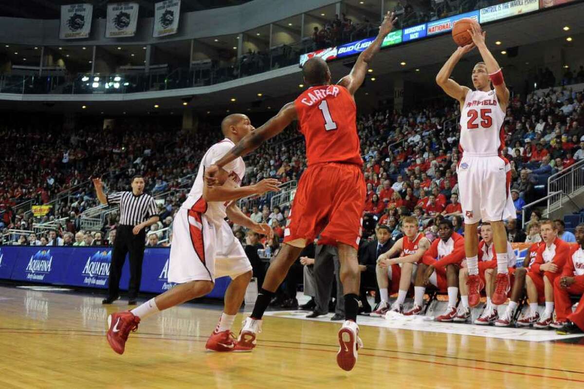 Fairfield University's Colin Nickerson takes a shot as Marist's Dorvell Carter defends during Saturday's MAAC quarterfinal game at Webster Bank Arena at Harbor Yard on March 5, 2011.