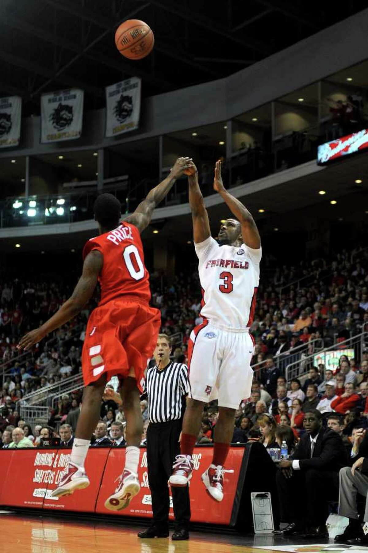 Fairfield University's Derek Needham takes a shot as Marist's Devin Price defends during Saturday's MAAC quarterfinal game at Webster Bank Arena at Harbor Yard on March 5, 2011.