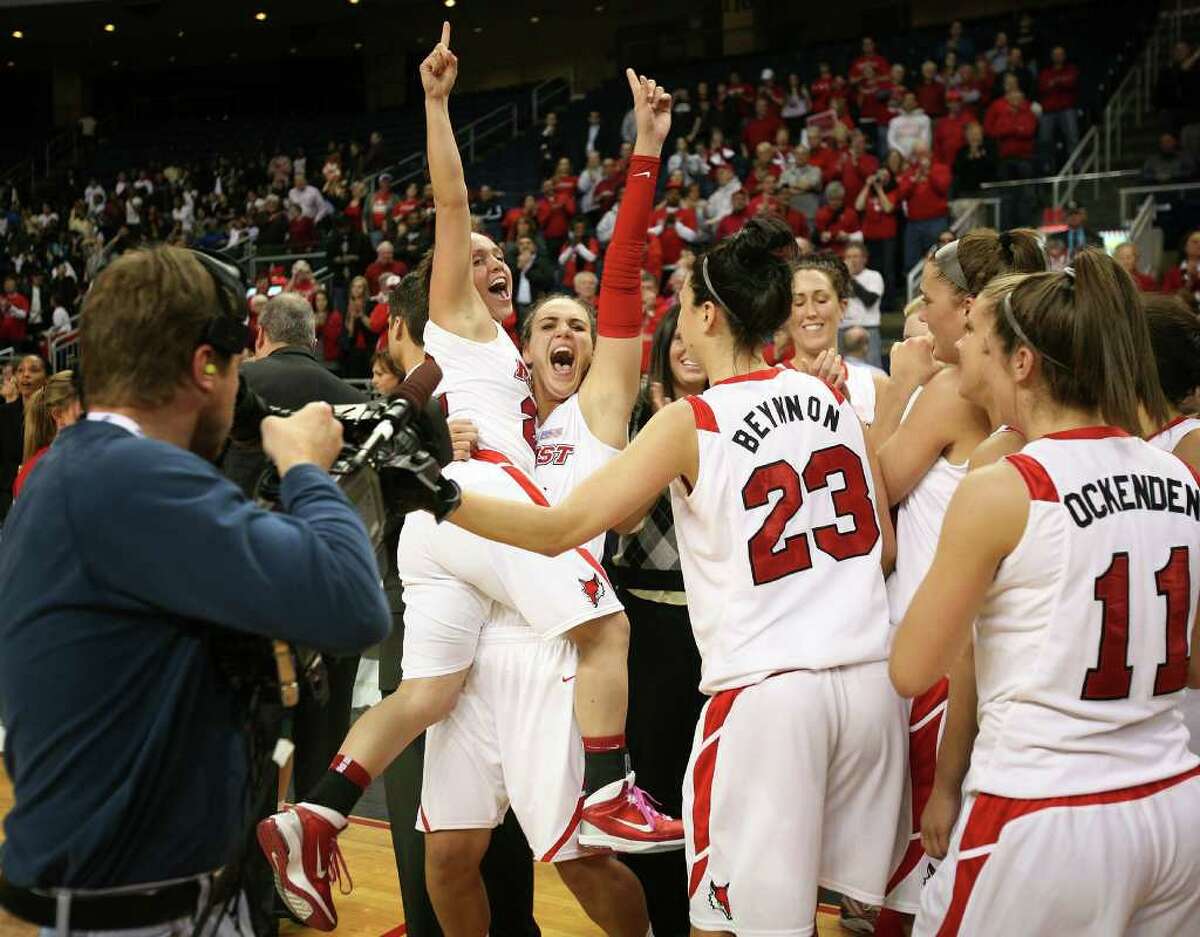 Marist's Kristine Best is lifted by teammate Maria Laterza as they flash the number one sign following their victory over Loyola in the finals of the MAAC conference tournament at the Webster Bank Arena at Harbor Yard in Bridgeport on Monday, March 7, 2011. Marist won the game 63-45.