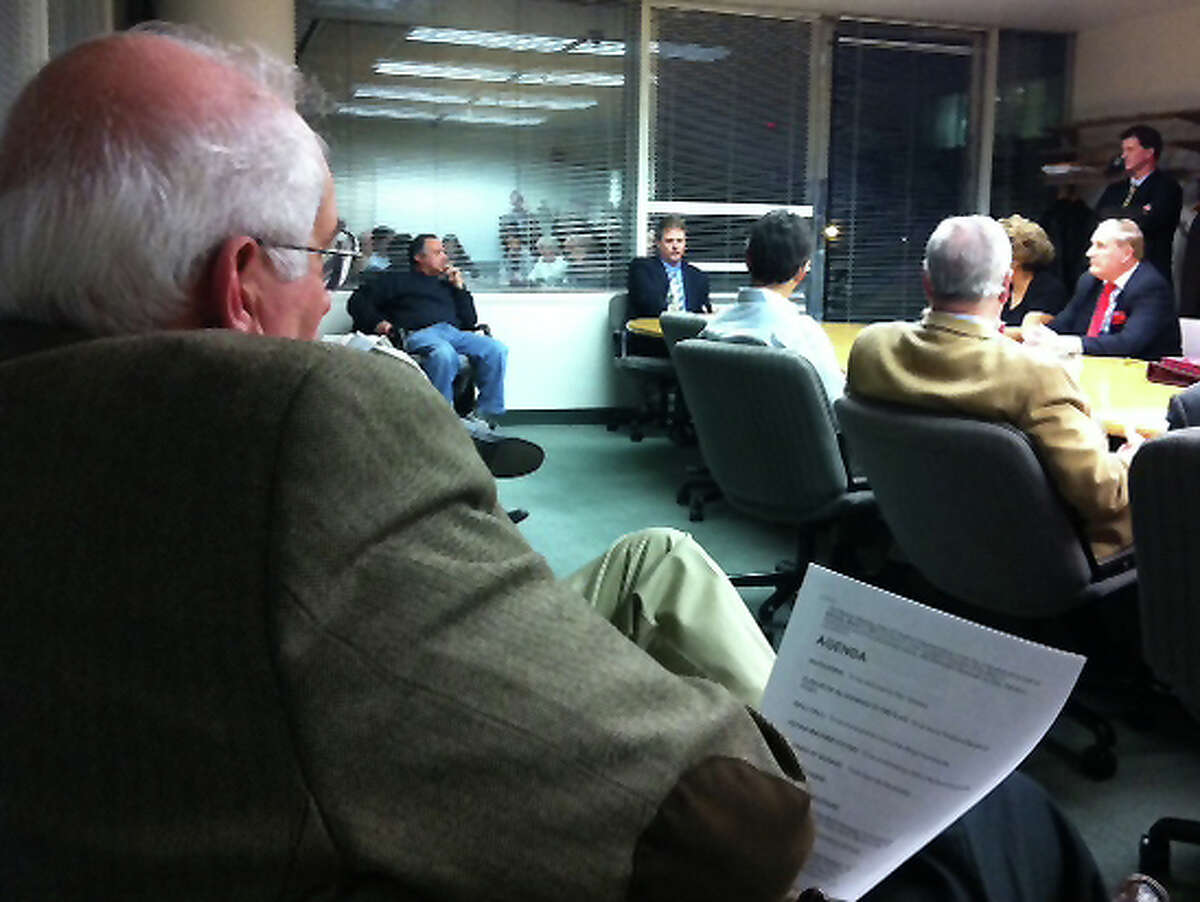 Former Board of Finance Chairman Joe Tarzia, left, watches Monday night as the Board of Representatives Appointments Committee interviews Kieran Ryan, center, for the Board of Finance seat Tarzia vacated.