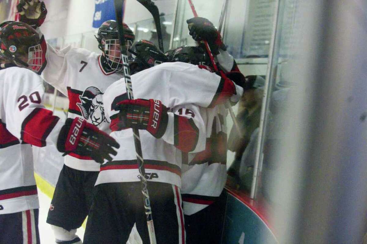 The Rams celebrate their first goal which was quickly followed by two more in the final minutes of the second period as New Canaan faces Greenwich in a boys hockey game at the Darien Ice Rink in Darien, Conn., March 9, 2011.