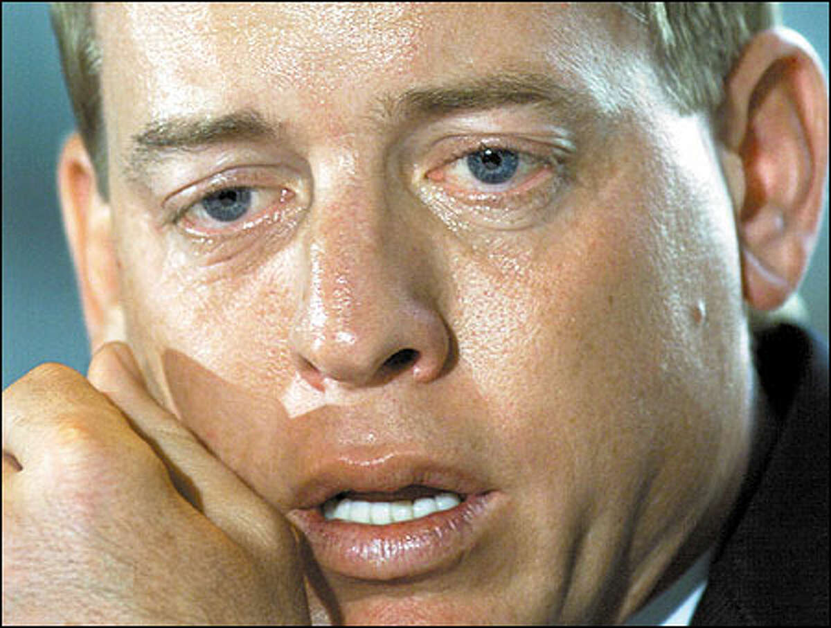 Former Dallas Cowboy quarterback Troy Aikman pauses during a news conference where he announced his retirement from the NFL in Irving, Texas. Aikman was waived by the Cowboys on March 7, a day before he was due a $7 million bonus and seven-year contract extension.