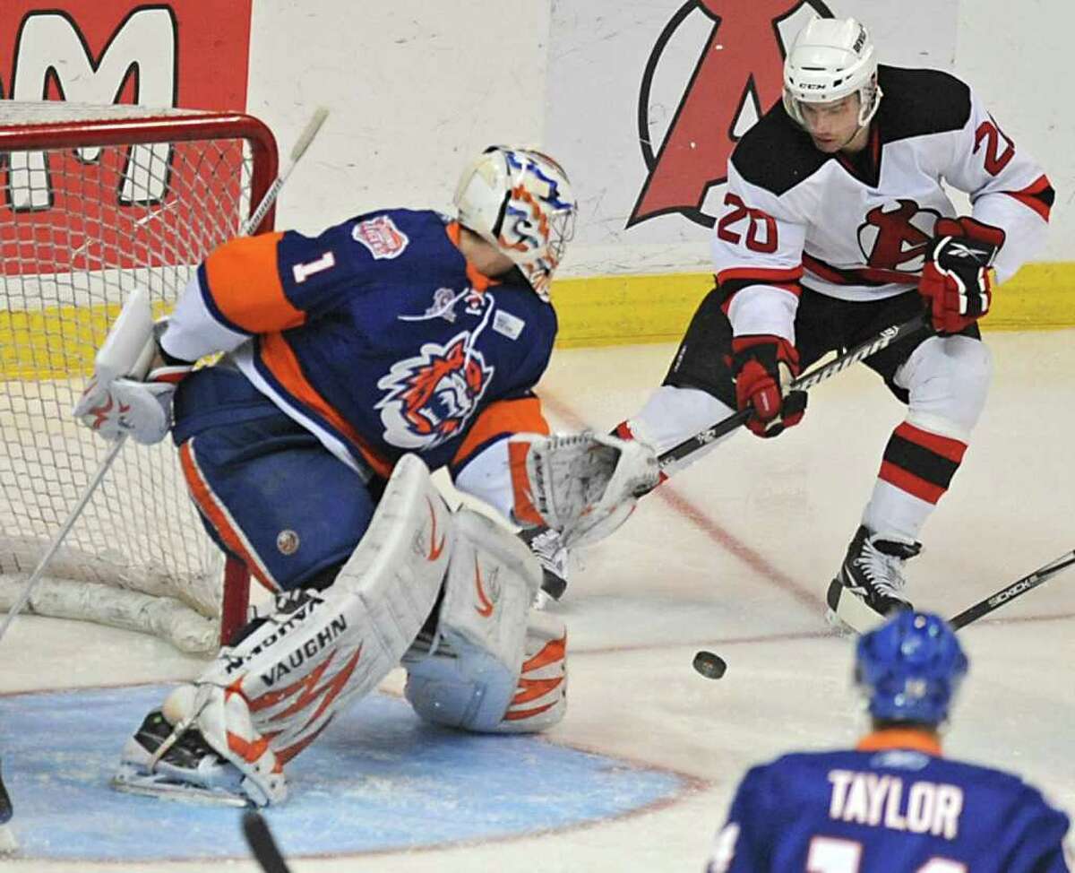 Darcy Zajac, #20 of the Albany Devils, tries but cant' get the puck past Goalie Mikko Koskinen, of Bridgeport, during a hockey game at the Times Union Center in Albany, NY on Wednesday, March 9, 2011. (Lori Van Buren / Times Union)