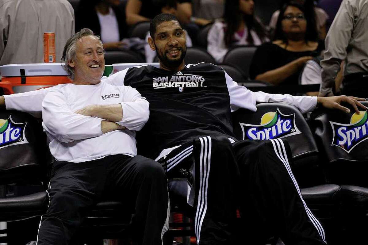 SPURS -- San Antonio Spurs Tim Duncan shares a laugh with Strenth and Conditioning Coach Mike Brungardt before their game aginst the Detroit Pistons at the AT&T Center, Wednesday, March 9, 2011. JERRY LARA/glara@express-news.net