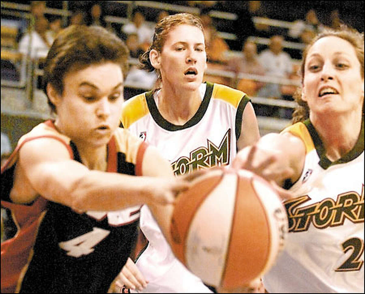 Storm rookie Lauren Jackson, center, looks on while teammate Katy Steding, right, tries to steal the ball from Portland's Tully Bevilaqua.