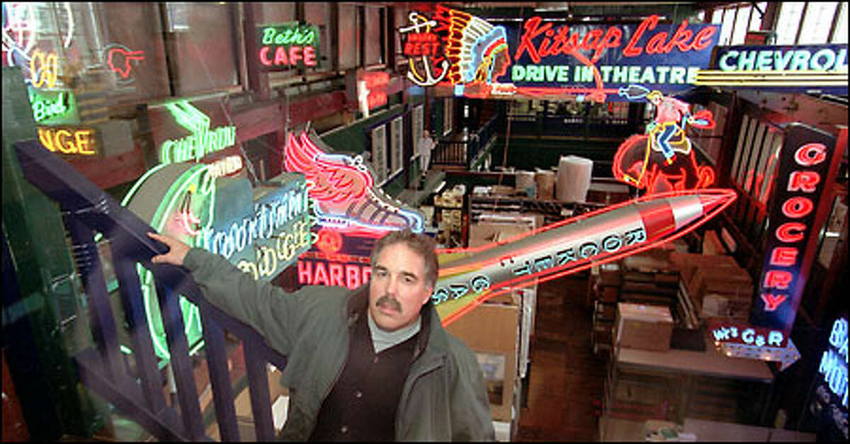 Scott Andrews, dentist and co-owner of Smile Seattle Investments, surrounds himself with neon at his Sodo warehouse office. Andrews has collected and restored over 60 neon signs.
