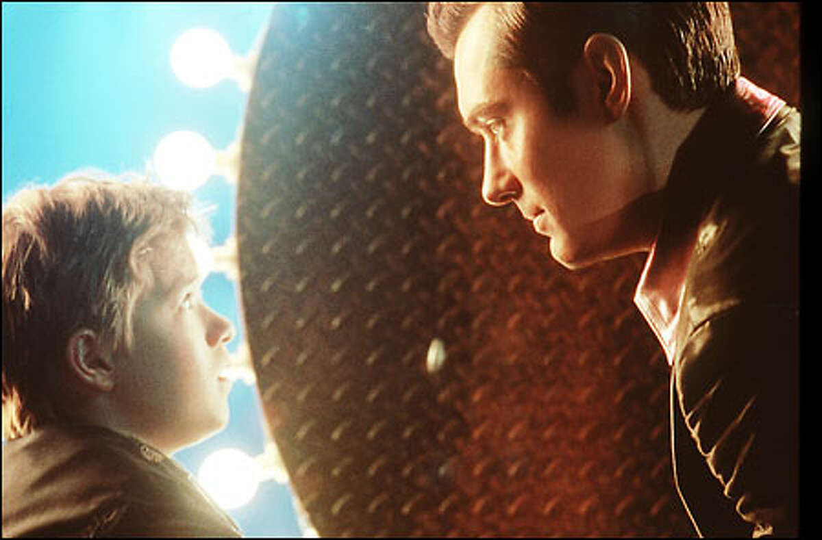 Haley Joel Osment, left, plays the first child robot capable of love, designed to ease the loneliness of a childless couple; Jude Law is Gigolo Joe, a robot who services lonely women.