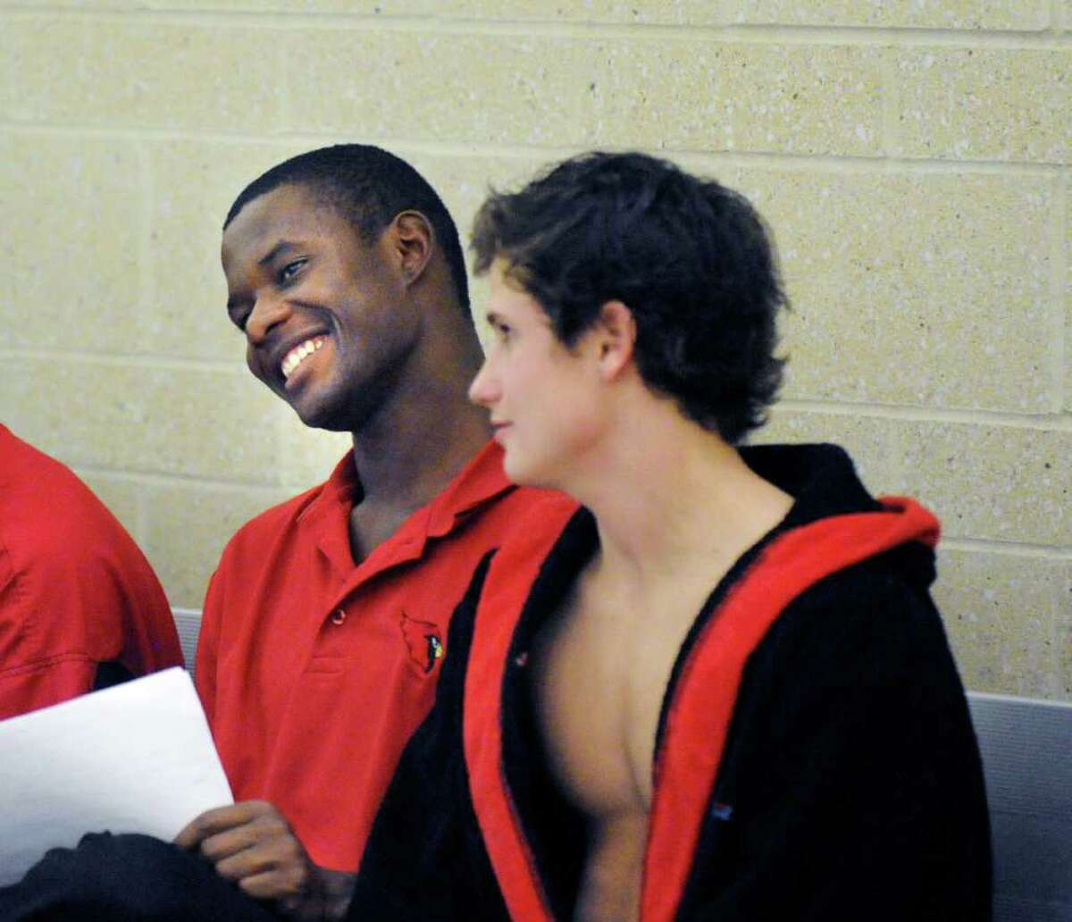 Greenwich HIgh School diving coach Kevin Thompson smiles after speaking with his top diver, Connor Brisson, right, after a Brisson dive during the Class LL Diving Finals at Hamden High School, Thursday, March 10, 2011.