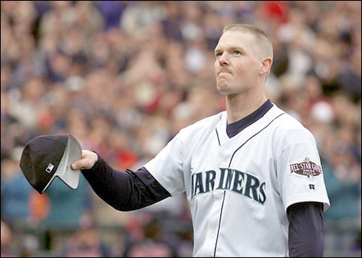 Mariners right-hander Jeff Nelson acknowledges the crowd in the eighth inning after being relieved by Arthur Rhodes. Nelson struck out four Indians in his 1 2/3-inning appearance.
