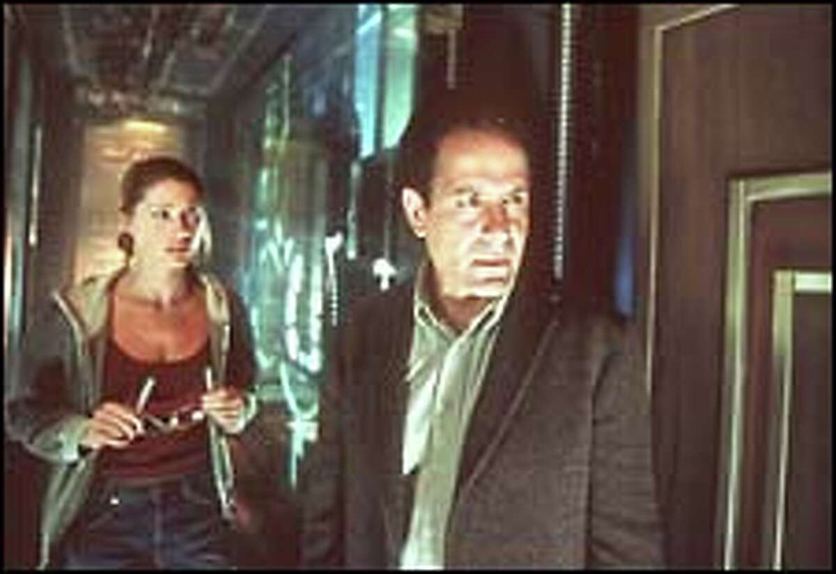 Shannon Elizabeth and Tony Shalhoub are two of the reluctant ghost hunters.