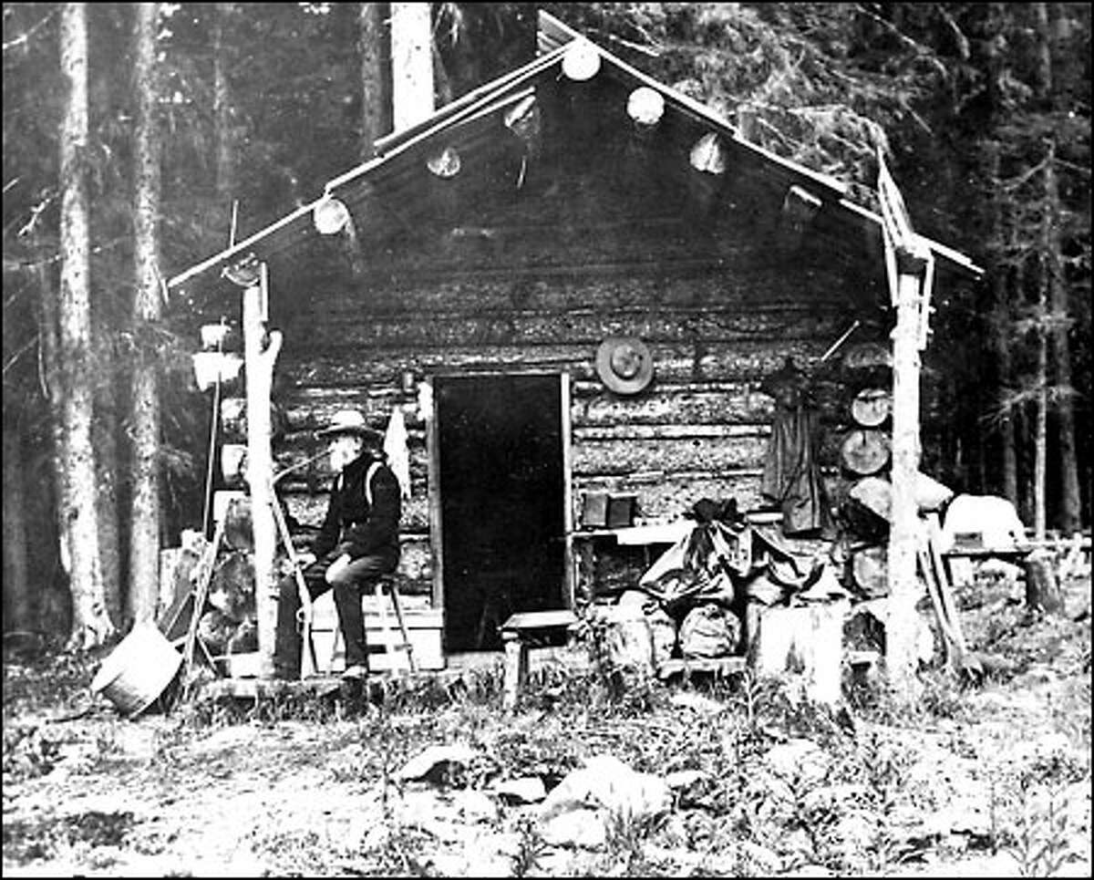 Denny at a cabin used during 1899 construction of a Snoqualmie Pass road.
