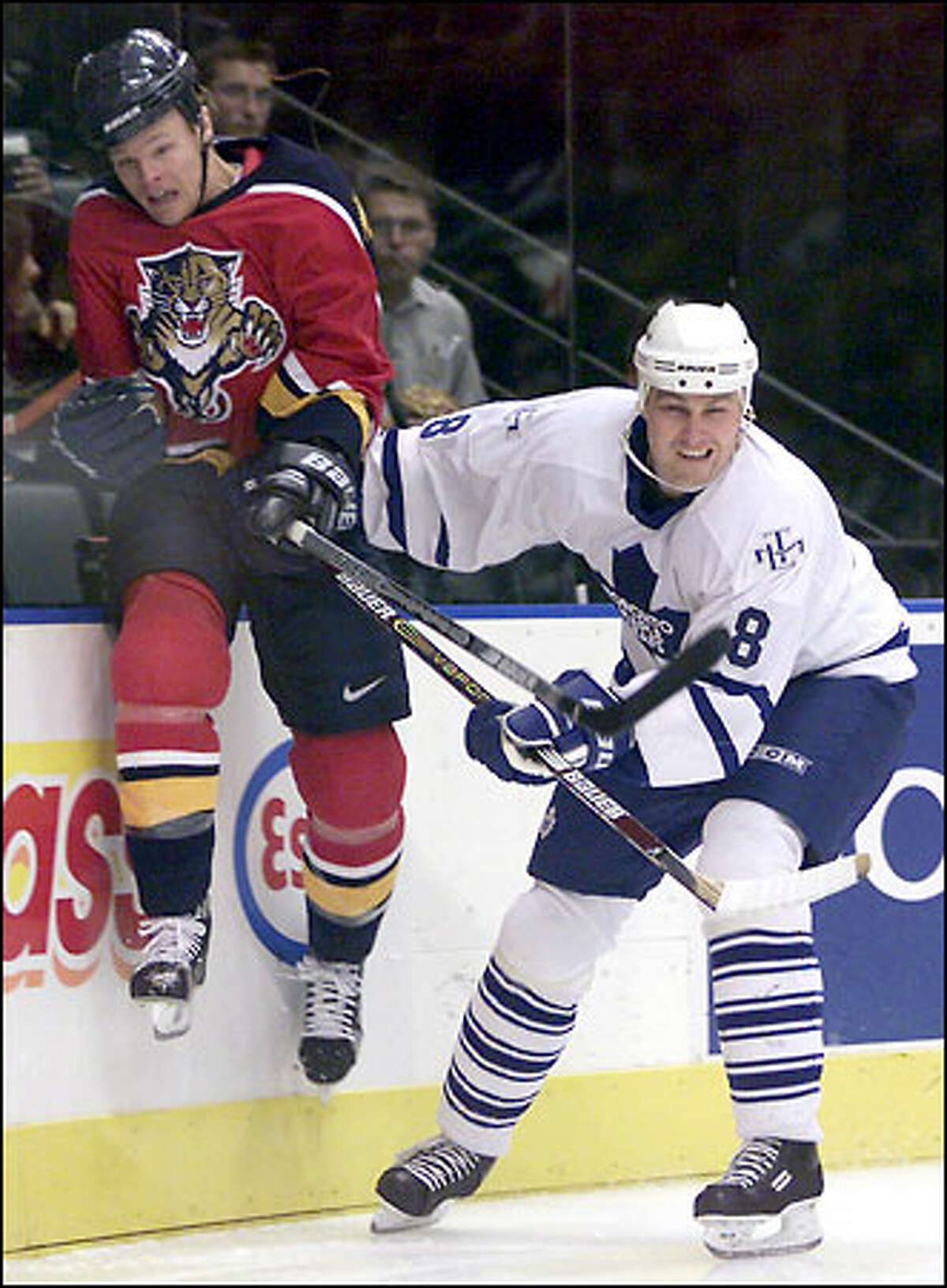 Toronto defenseman Aki Berg hammers Florida center Kevyn Adams up and into the boards during the Maple Leafs' 5-1 victory.