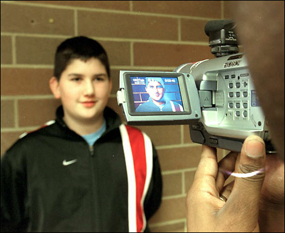Zack Jones, a seventh-grader at Maplewood Co-op, a school in Lynnwood, is videotaped for a holiday-greeting message that will be sent around the world to members of the U.S. armed forces.