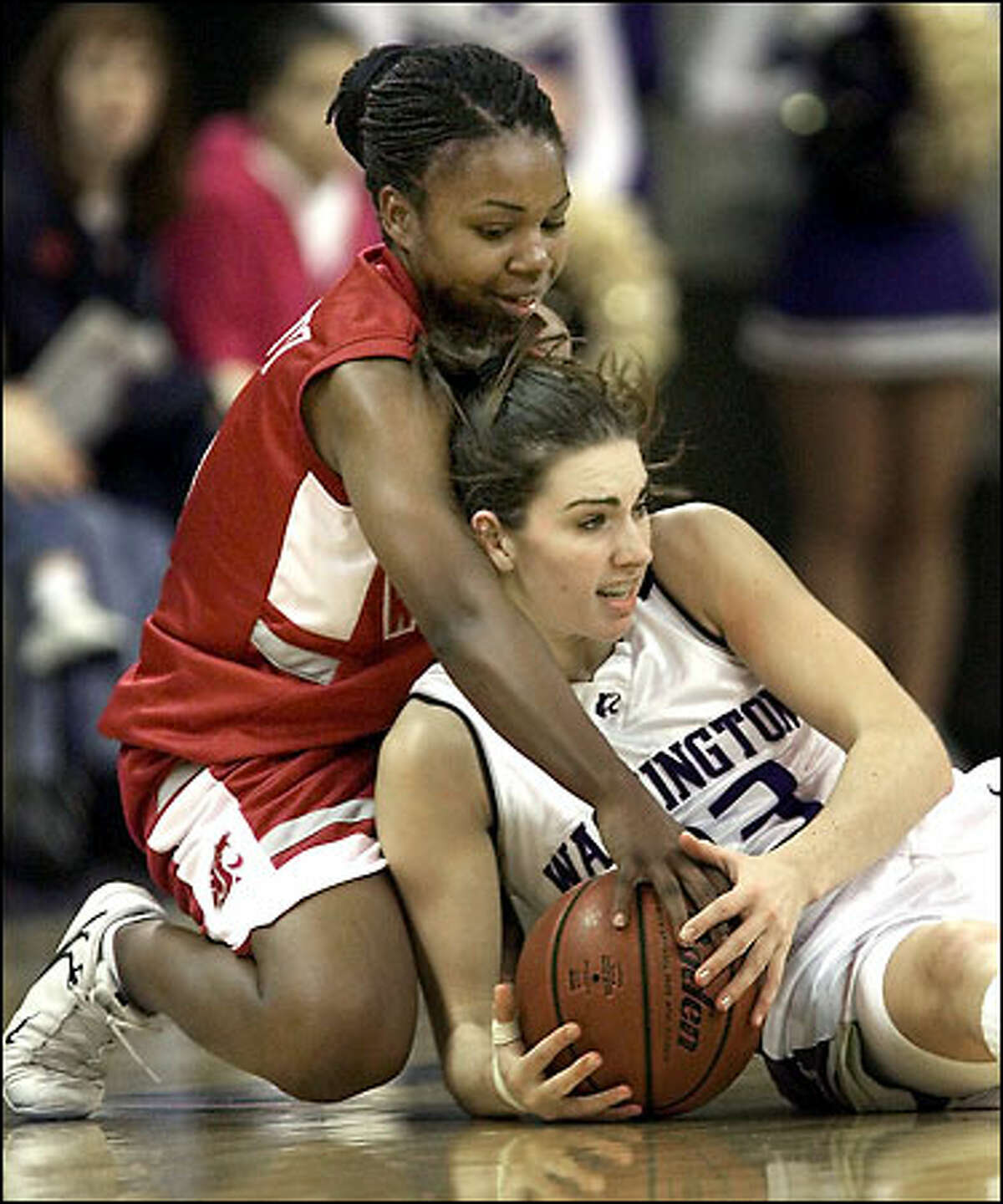 Washington State's Jessica Perry, left, and Washington's Kristen O'Neill battle for a ball during first half play at Hec Edmundson Pavilion.