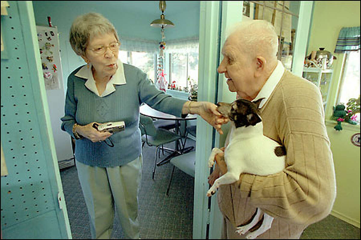 Frank and Ellie Darulis with their dog, Katie. The couple finds money for both the P-I Readers Care Fund and the Fred Hutchinson Cancer Research Center.