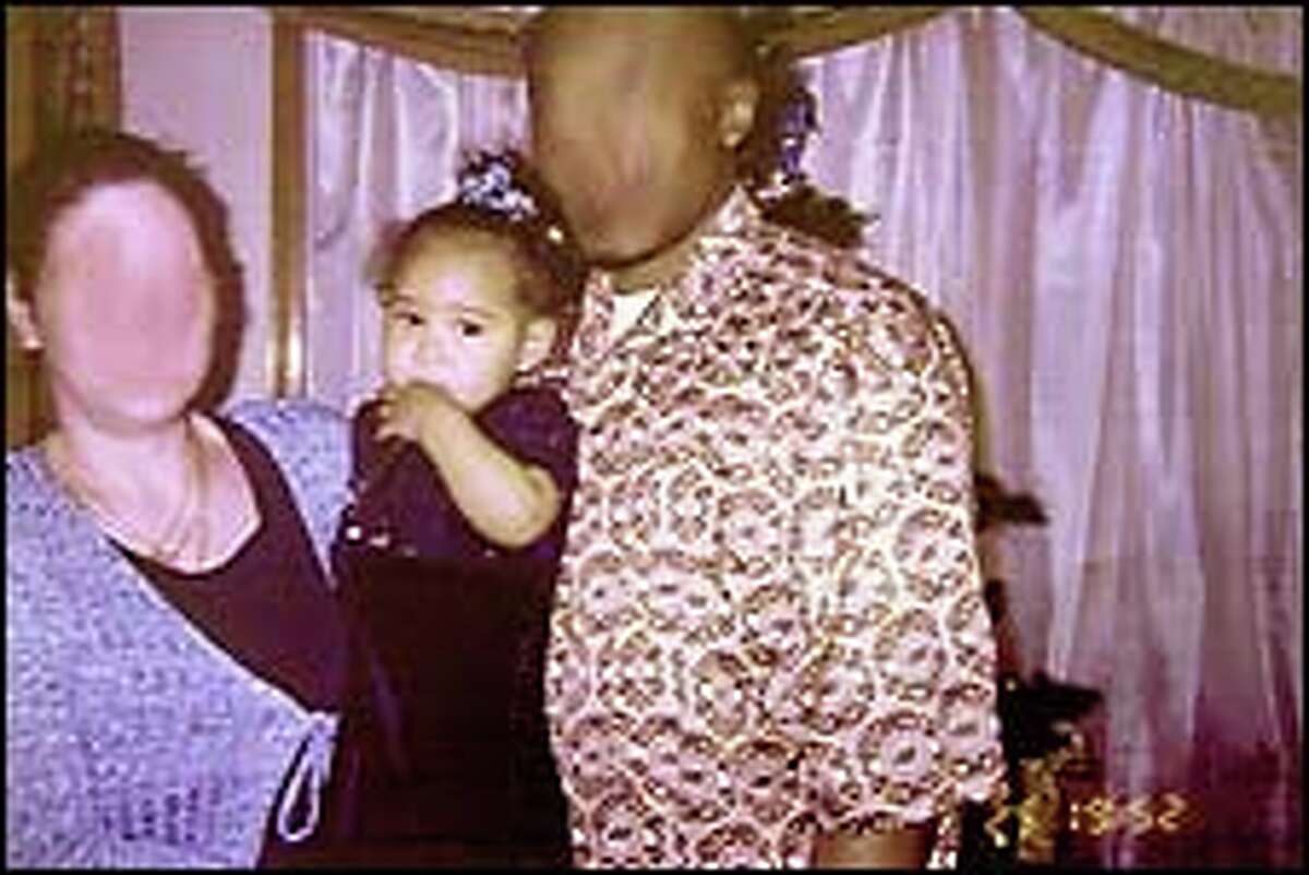In a photo released by the Chicago police with the two faces intentionally blurred, abducted Jasmine Anderson is shown with kidnap suspect Sheila Matthews, left, and her boyfriend, who was not identified. The photo was taken Christmas Day in the Chicago house of relatives of the boyfriend.