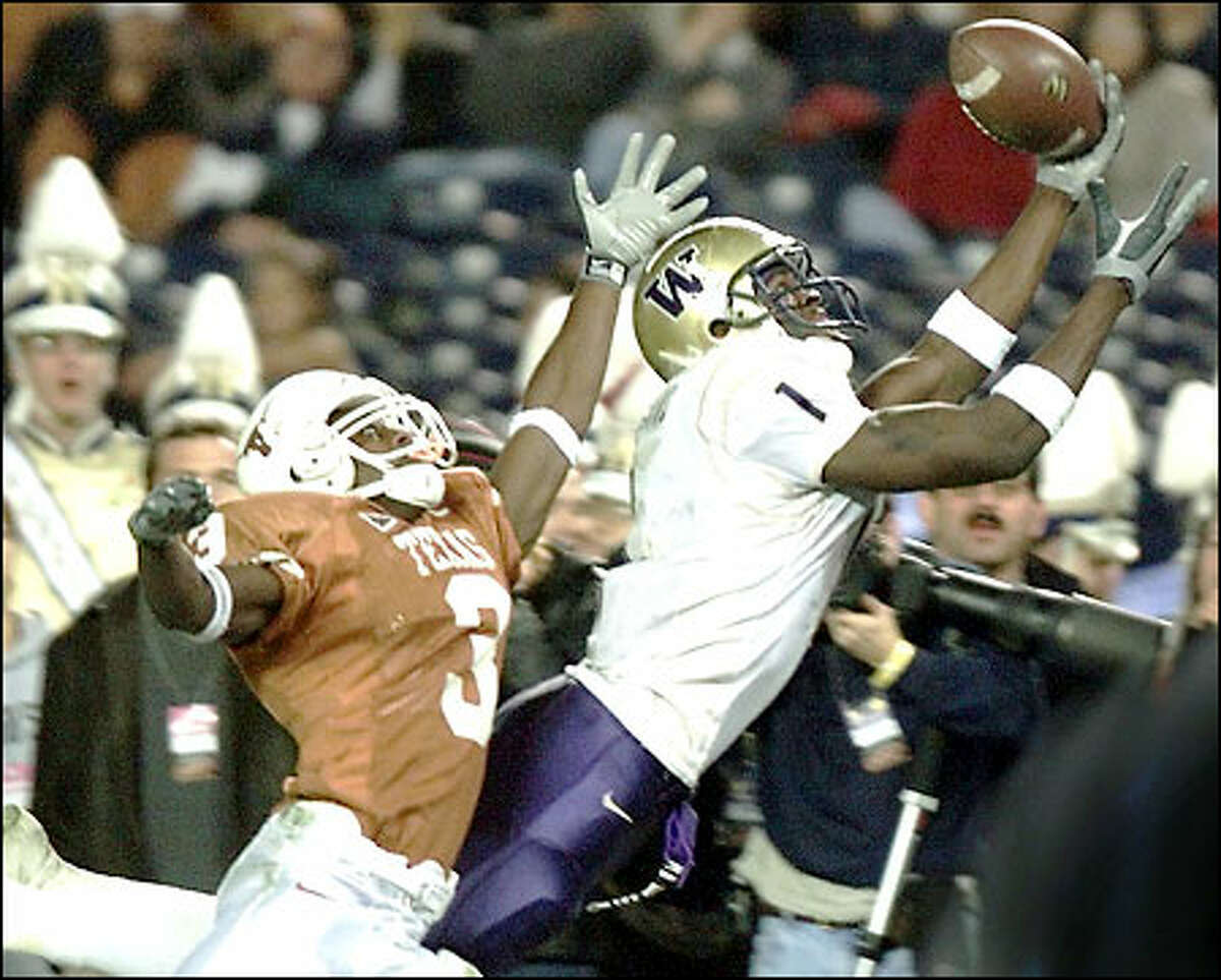Washington wide receiver Reggie Williams gets a hand on a Cody Pickett pass with time running out in the second quarter, but was unable to hold on. Texas' Nathan Vasher defends.