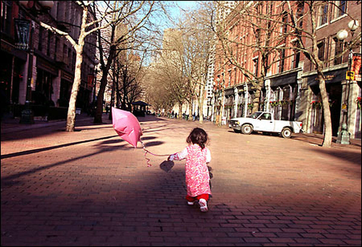 2002 here I come ... Azura Tyabja, 19 months, runs down the street near where her mother works in Pioneer Square. The area is hoping for a better year than the one it's just had.