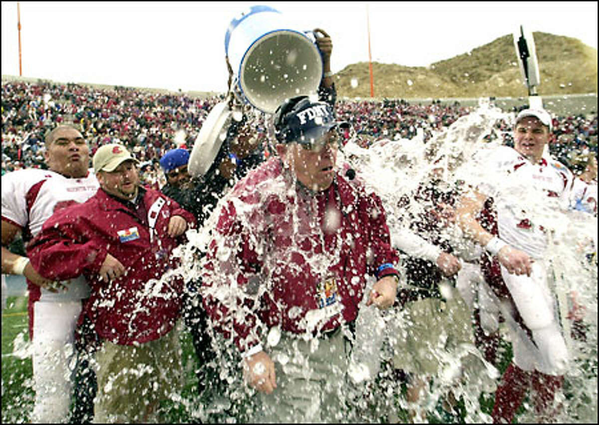 Washington State coach Mike Price gets dunked during the closing minutes of the Sun Bowl. Price improved to 3-1 in bowl games for the Cougars.