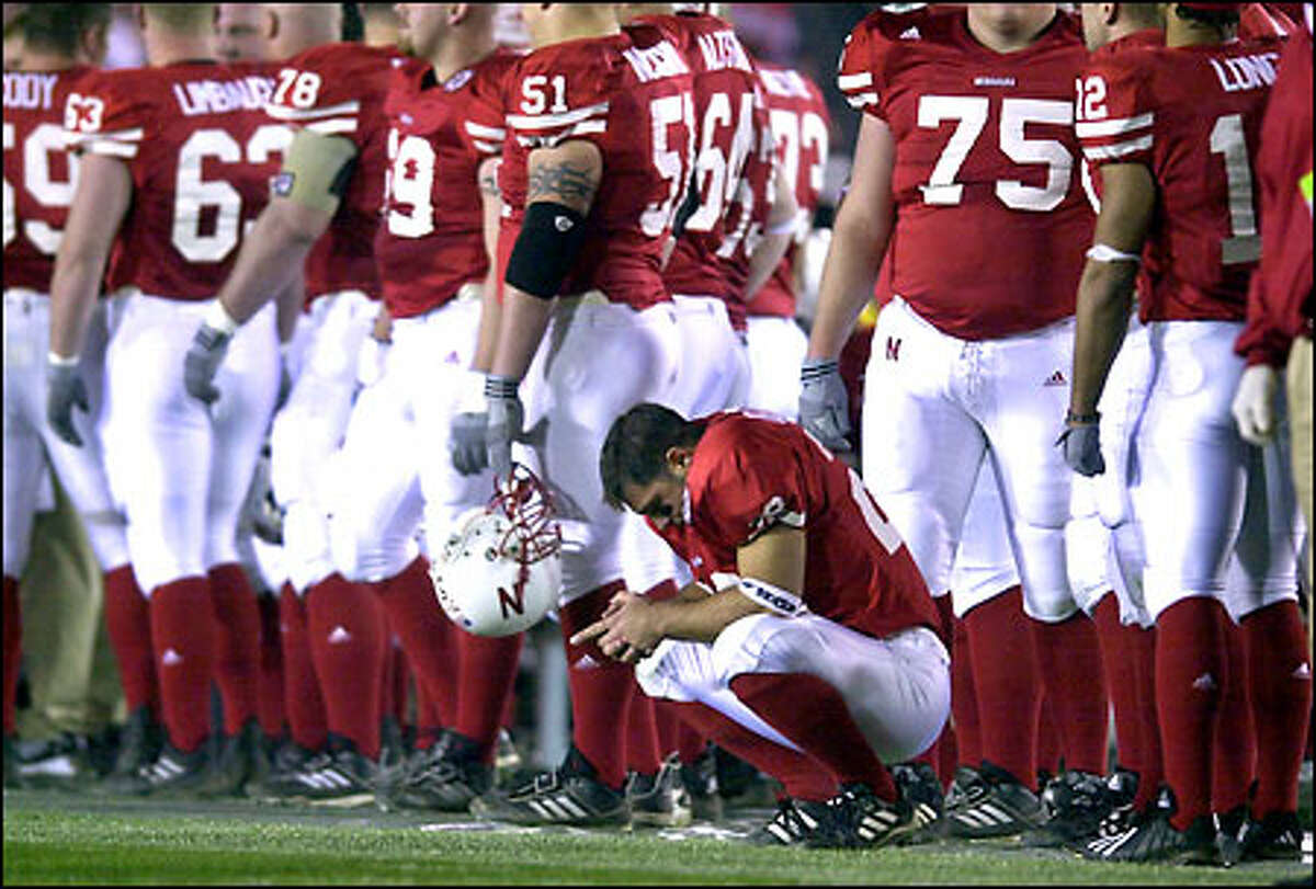 Nebraska kicker Sandro DeAngelis crouches and lowers his head after Miami's James Lewis returned an interception for a touchdown in the second quarter.