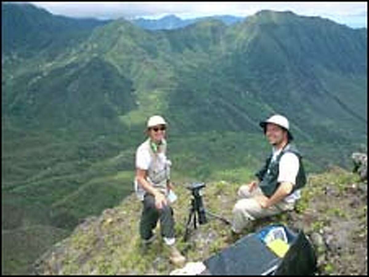 Photographing the photographers: Susan Middleton, left, and David Liittschwager on Ohikilolo Ridge on Oahu, where they shot native plants.