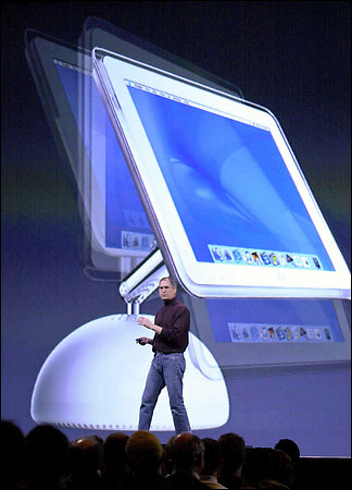 Apple Computer CEO Steve Jobs introduces the new flat-screen iMac at Macworld Expo in San Francisco yesterday. The display swivels on its base.
